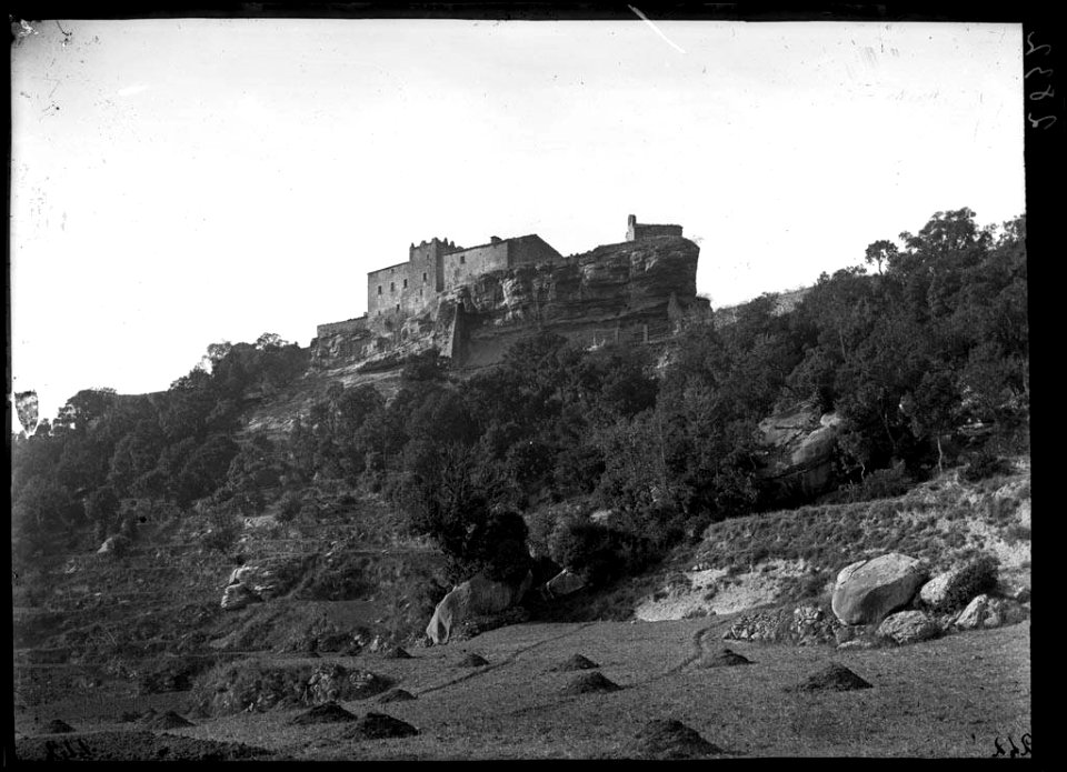 El castell de Castellcir voltat de boscos i amb un camp en primer terme (AFCEC VINTRO D 2832)