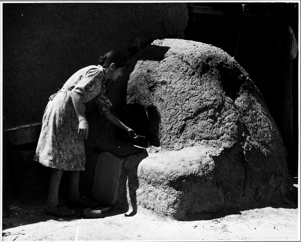 El Cerrito, San Miguel County, New Mexico. Bread is home-baked here, and usually it is made in adob . . . - NARA - 521196