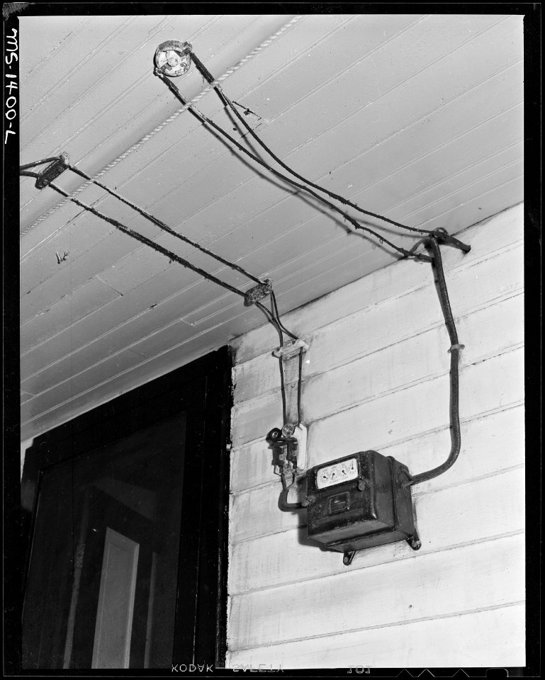 Electricity meter and wiring on the porch of house occupied by James Robert Howard. This house is about fifty years... - NARA - 540781