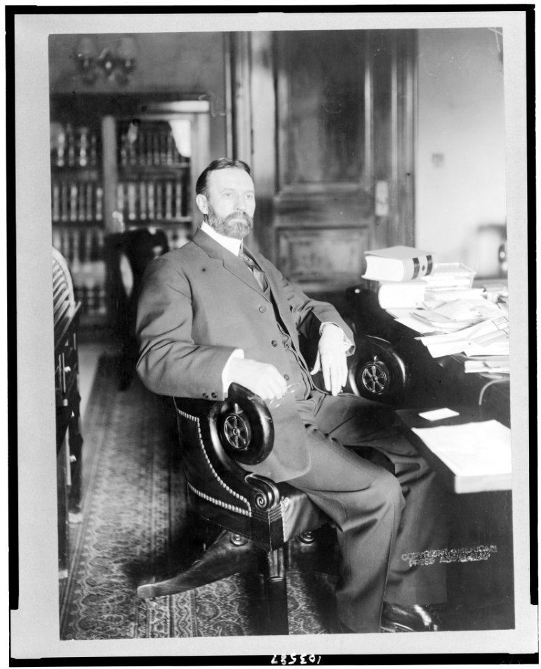 George Sutherland, full-length portrait, seated at desk, facing right LCCN91783840