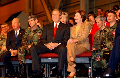 George W. Bush and Laura Bush sit together on the stage before a full house in Hangar 3 at Elmendorf Air Force Base, Alaska photo