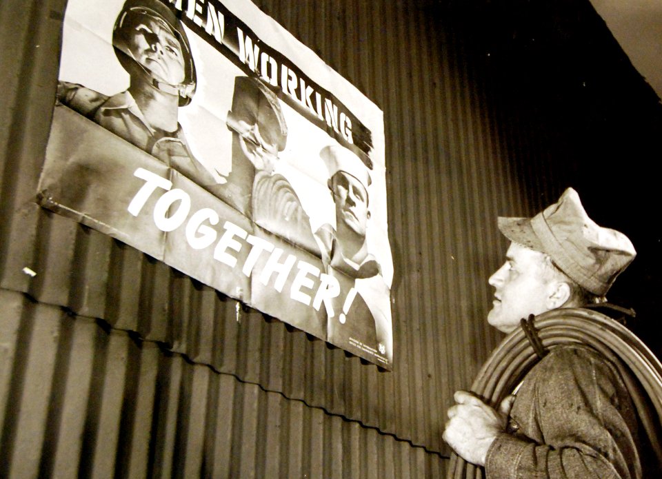 George Woolslayer, a welder at Allegheny-Ludlam Steel Mill, views his image on poster, WWII (25720095454)