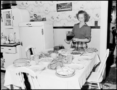Geraldine Fain, daughter of Harry Fain, coal loader, completes setting of table for Sunday dinner. Inland Steel... - NARA - 541437