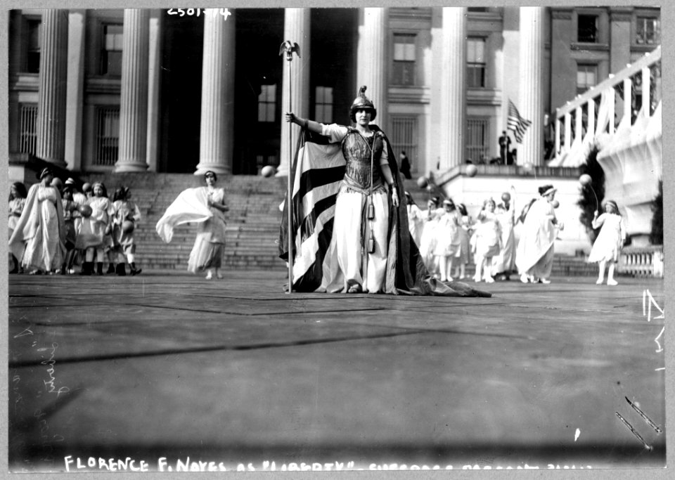 German actress Hedwig Reicher wearing costume of Columbia with other suffrage pageant participants standing in background in front of the Treasury Building, March 3, 1913, Washington, D.C. LCCN97510759