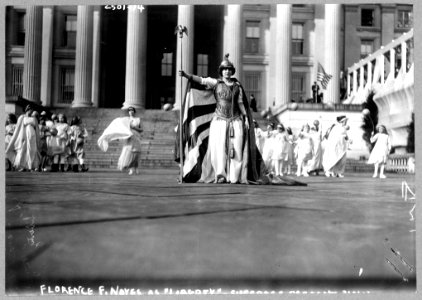 German actress Hedwig Reicher wearing costume of Columbia with other suffrage pageant participants standing in background in front of the Treasury Building, March 3, 1913, Washington, D.C. LCCN97510759