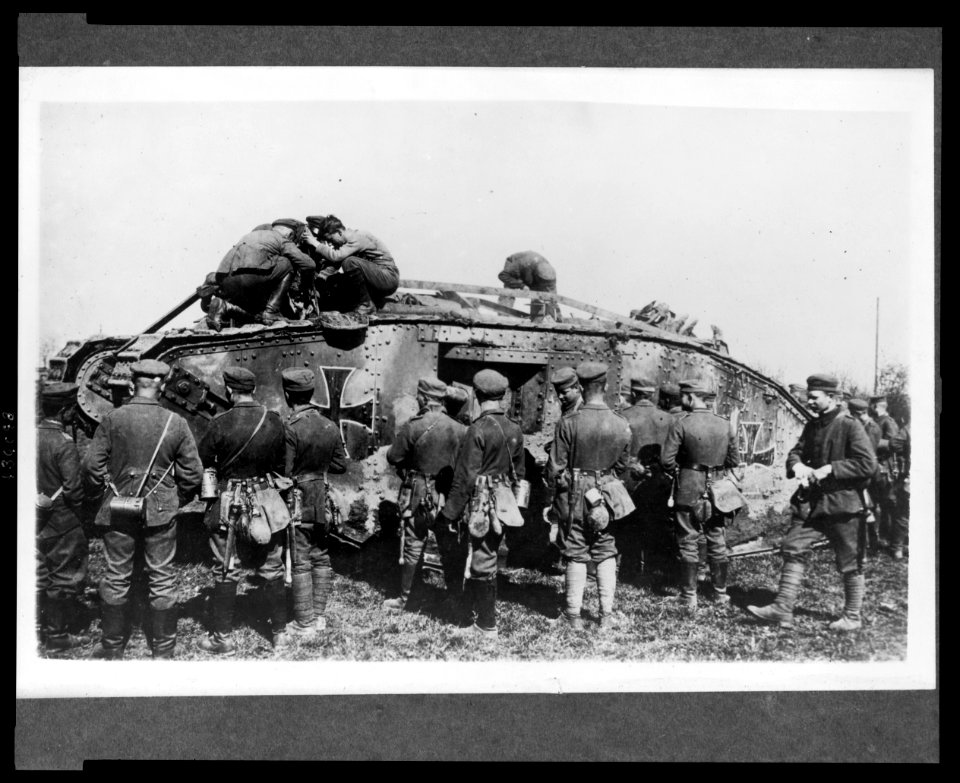 German soldiers standing around a German tank as other soldiers work on the tank LCCN2005697183