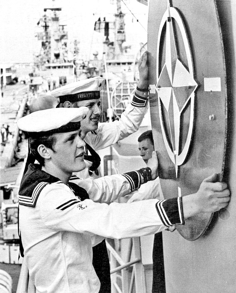 German sailors mounting the NATO emblem on the frigate Braunschweig (F225), in 1972