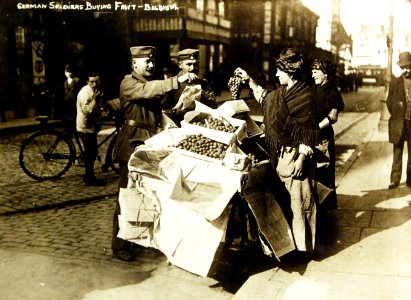 German soldiers buying fruit in Belgium during German occupation, WWI (29845421706) photo