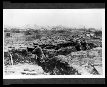 German soldiers in a trench; in background, a town LCCN2005697186
