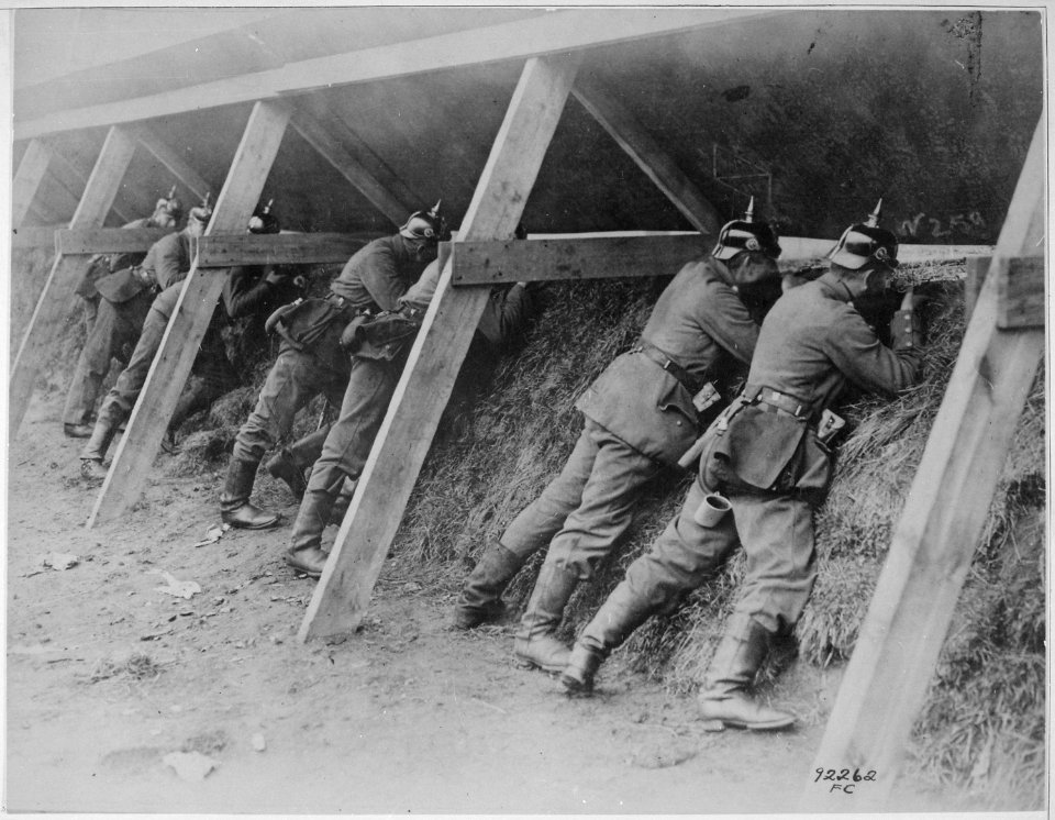 Germans in their well protected trenches on the Belgian frontier showing the men in the act of aiming at their enemy.... - NARA - 533681
