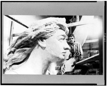 Ellen Houser Rankin, three-quarter length portrait, seated, facing front, with sculpture of Pelee's head LCCN92514233