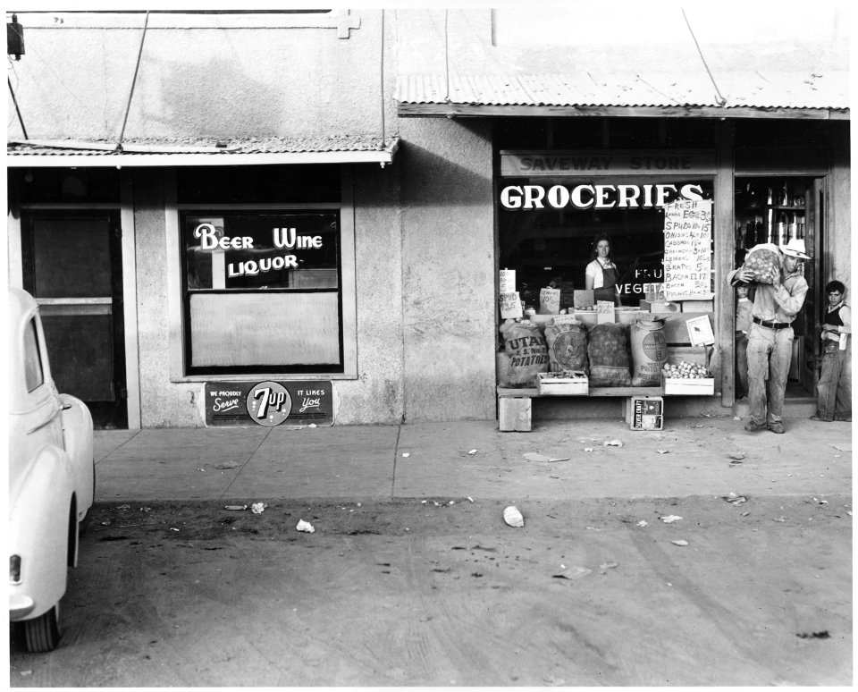 Eloy, Pinal County, Arizona. Main street of Eloy. Cotton picker comes to town on Saturday afternoon . . . - NARA - 522513