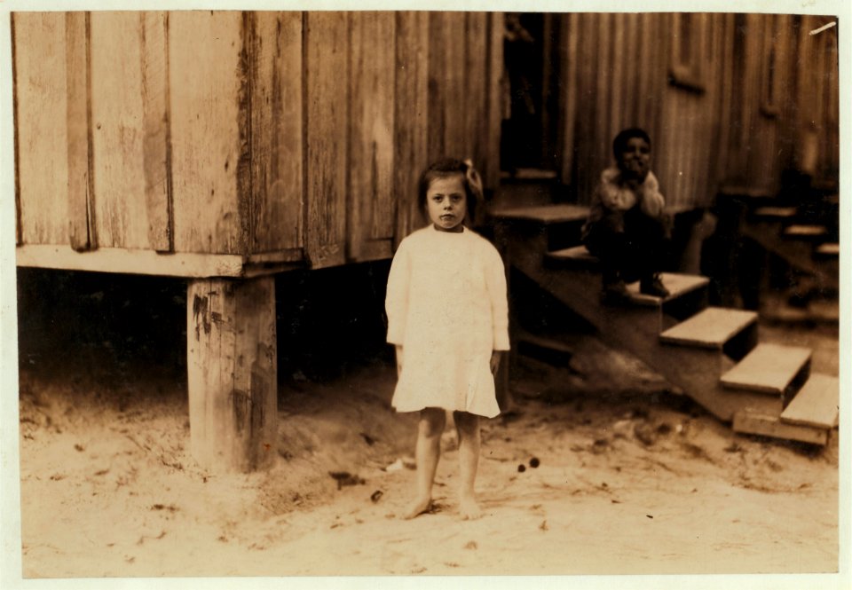 Emma Kelly, eight years old, picks shrimp in the Peerless Oyster Co. Many like her worked from 3-00 A.M. until 4-00 P.M. LOC nclc.00904