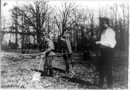 Emperor Nicholas II working in the kitchen garden at Tsarskoe Selo. Behind him is the officer of the guard LCCN2007683269