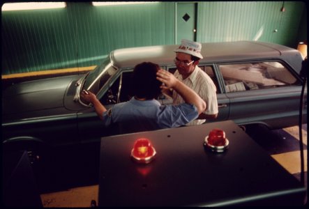 Employee of an Auto Emission Inspection Station in Norwood Ohio, Talking to a Customer Whose Station Wagon Has Just Failed the Carbon Monoxide Emission Test...08-1975 (4266527294)