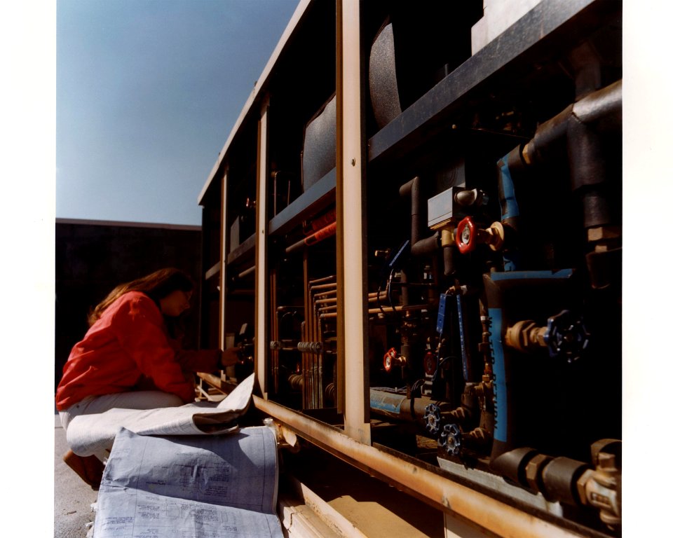 Engineer checking controls on heat pump