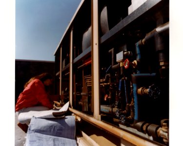 Engineer checking controls on heat pump