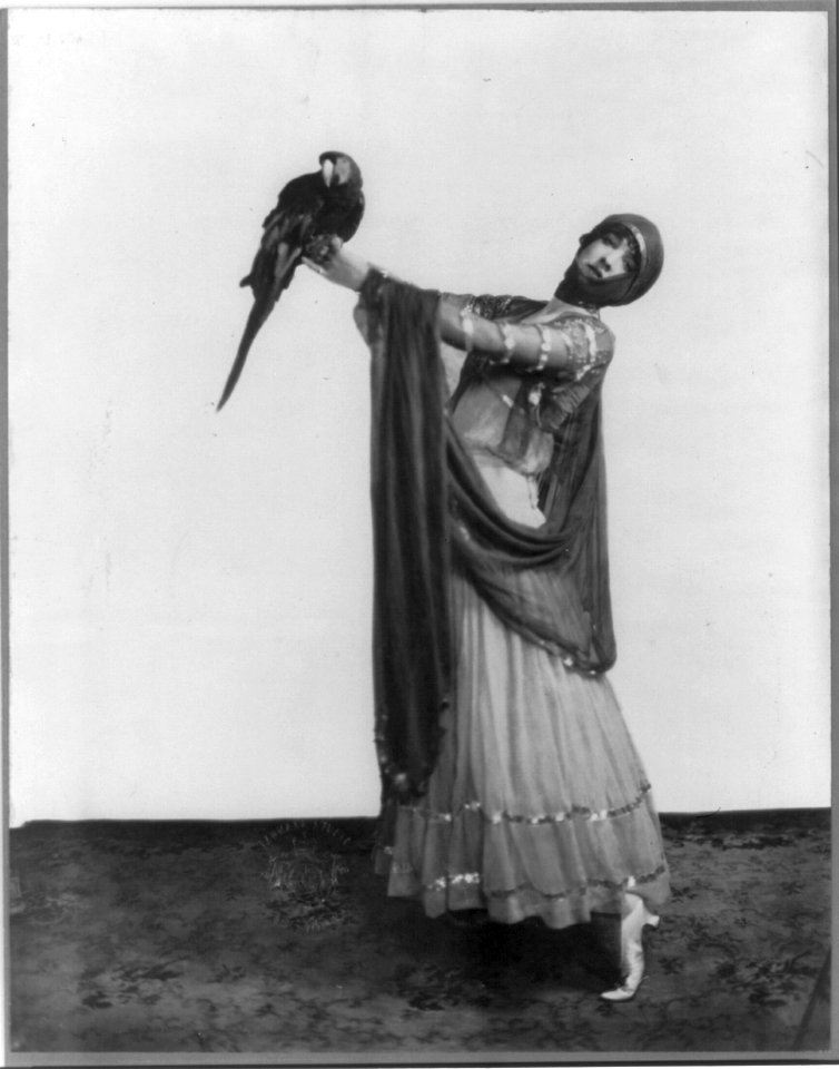Gertrude (Vanderbilt) Whitney, 1877-1942, full length, standing, facing slightly left; holding parrot LCCN2005688966