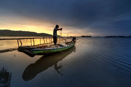 The fishermen silhouette the sun photo