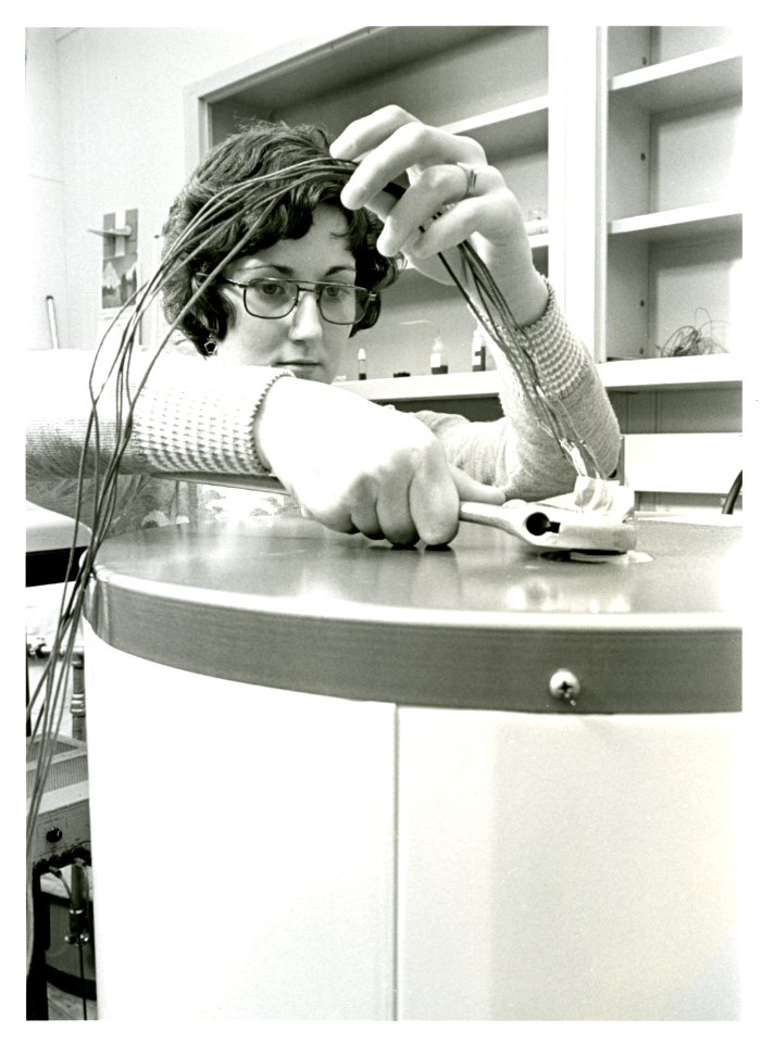 Engineering technician Robin Brese adjusts dials that measure the energy normally used by a hot water heater