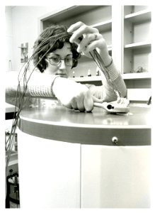 Engineering technician Robin Brese adjusts dials that measure the energy normally used by a hot water heater