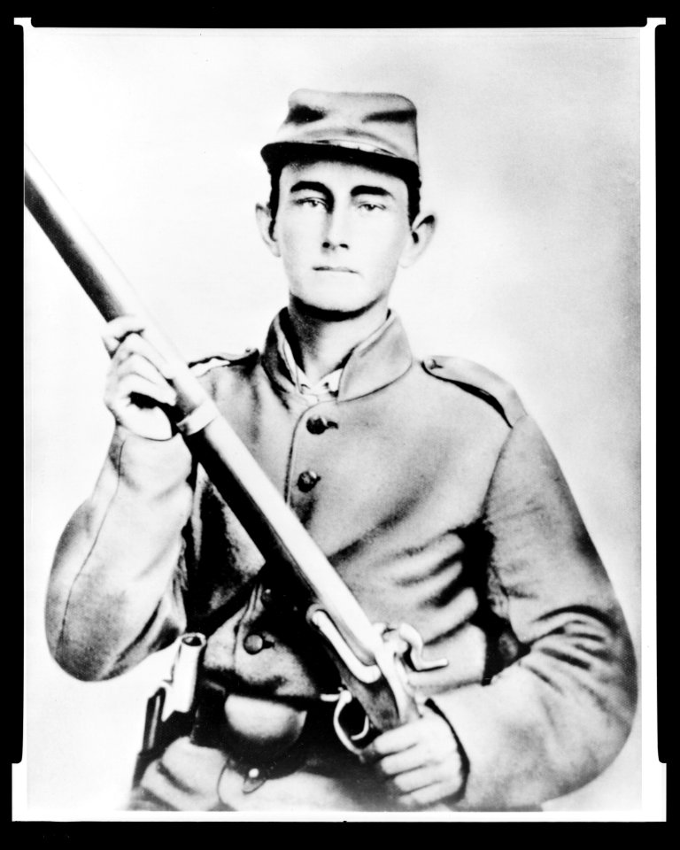Enoch Hooper Cook, Jr., Pvt, Co. H. 38th Alabama Infantry, C.S.A., half-length portrait, facing front holding rifle LCCN2005695743