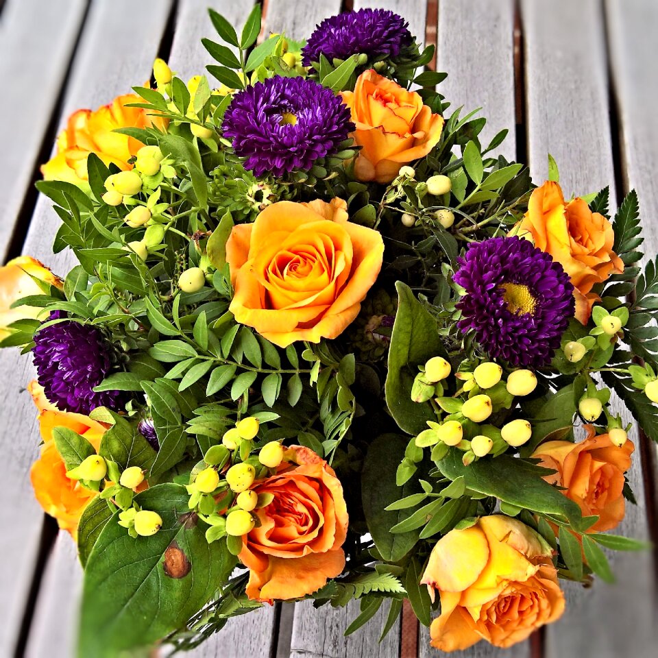 Yellow roses dark blue asters bound