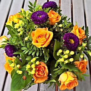 Yellow roses dark blue asters bound