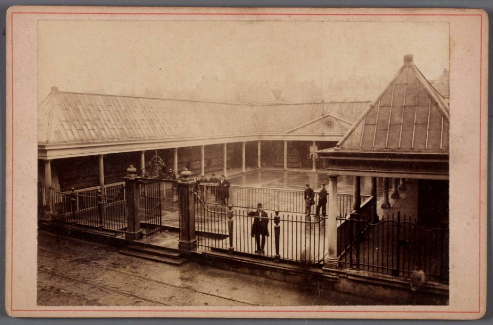 Gezicht op de binnenplaats van de oude Korenbeurs aan het Damrak met op de voorgrond de rails van de in 1876 geopende paardentramlijn Dam-Prins Hendrikkade
