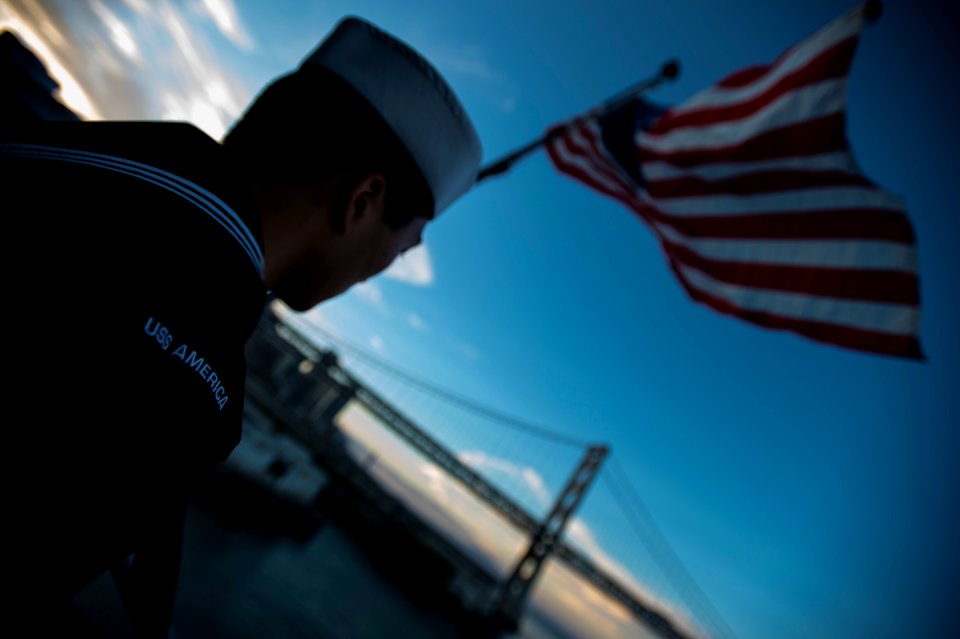 Evening colors aboard future USS America 141007-N-LD343-001