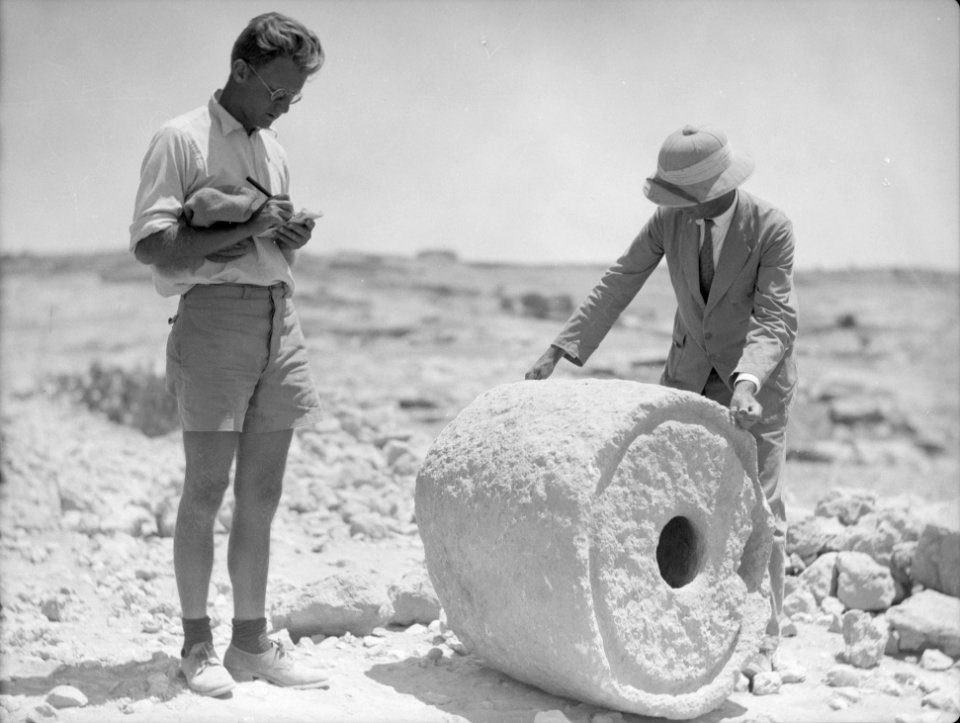 Excavations. Tell Beit Mirsim, (Kirjath Sepher). Excavators measuring an ancient dye vat, 1000 B.C. LOC matpc.15682