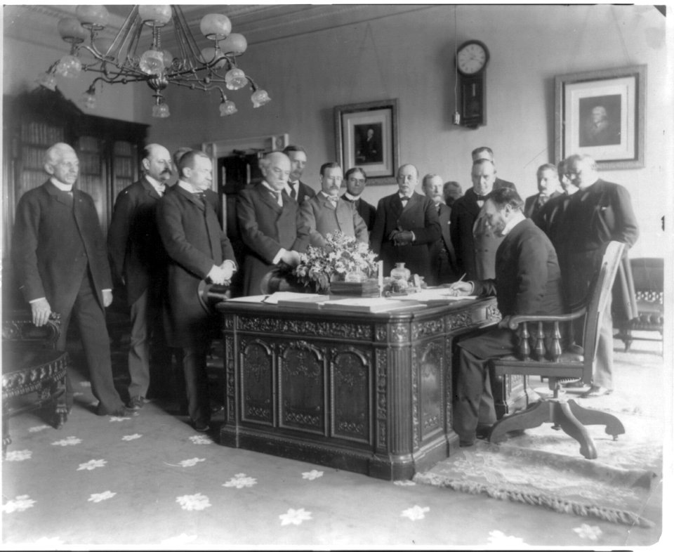 Exchange of the ratifications of the treaty of peace with Spain, made in the President's office, White House, Secretary of State John Hay signing LCCN2005688549