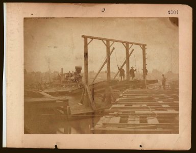 Exhibits the surface of a pair of barges, showing the tracks for loading and unloading cars, also the movable bridges by which the tracks on the floats are connected with those on the wharf LCCN2005696795