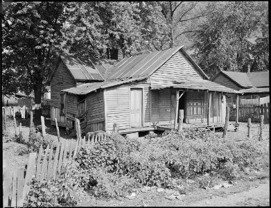 Exterior of three room house which rents for $4 monthly. This property, formerly owned by a coal mining company, is... - NARA - 541175
