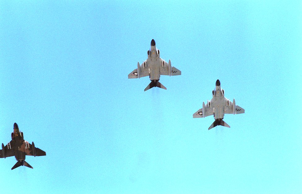 F-4 Phantom II aircraft from the Hawaii Air National Guard fly in a missing man formation to honor the Unknown Serviceman of the Vietnam Era. The serviceman's casket is being placed - DPLA - 9ae3786b4c052bda4e033b9645c48496