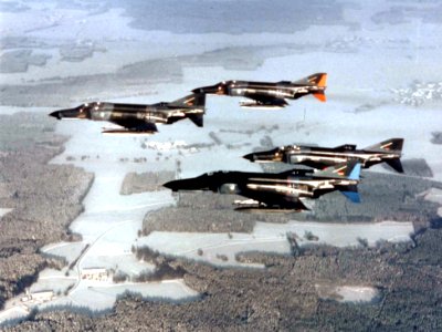 F-4F Phantoms in flight over snowy countryside