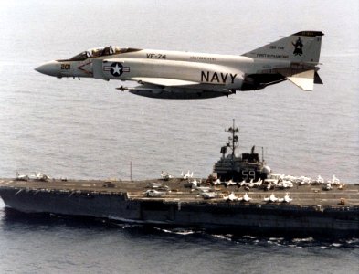 F-4J Phantom II of VF-74 in flight over USS Forrestal (CV-59), in 1981 (NNAM.1996.253.7268.022)