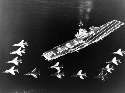 F-8E Crusaders of VF-62 fly over USS Shangri-La (CVA-38) in September 1965