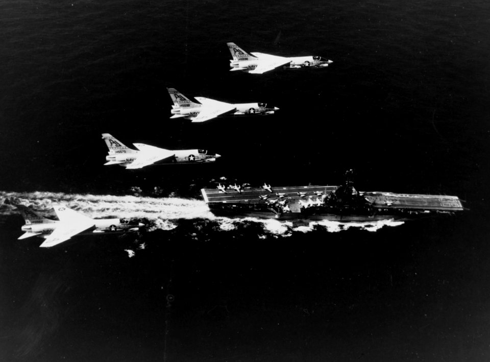 F-8C Crusaders of VF-62 fly over USS Shangri-La (CVA-38) c1968