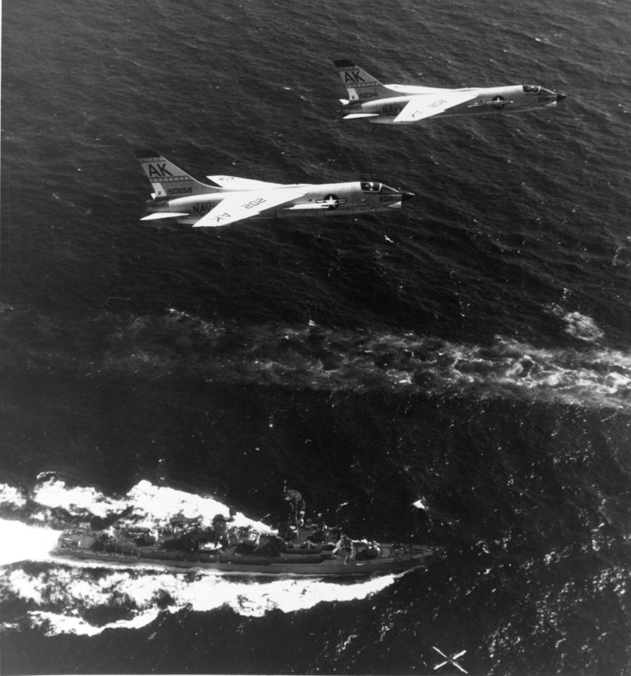 F-8E Crusaders of VF-62 fly over USS Claude V. Ricketts (DDG-5) in 1965