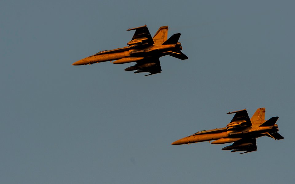 F-A-18C Hornets fly above USS Carl Vinson 141028-N-TP834-407