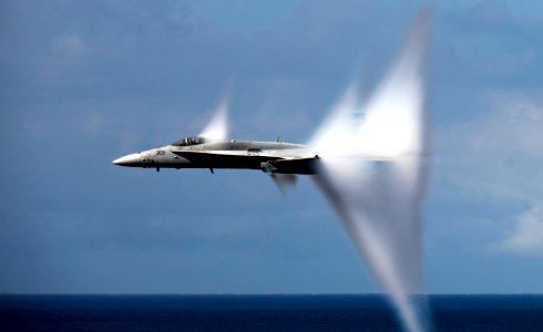 F-A-18C Hornet in transonic flight, with condensation cones