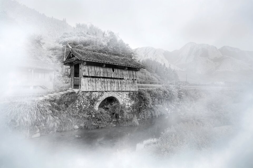 Mist covered bridge mountain village