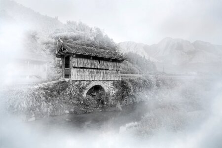 Mist covered bridge mountain village