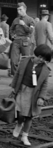 Girl detainee with Military Police detail, Woodland, California. Families of Japanese ancestry leave the station platform to board the train f . . . - NARA - 537810 (cropped) photo