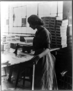 Girl painting strips with glue to assemble cigar boxes LCCN2006688476
