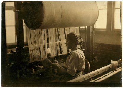 Girl at the drawing-in-frame of the weave-room, Lorraine Mills, Pawtucket, R.I. LOC nclc.02733
