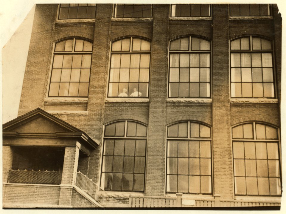 Girls flirting through window of Manomet Mill. LOC nclc.02522