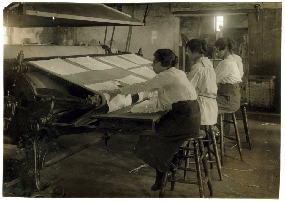 Girls working at mangle in Bonanno Laundry, 12 Foster Wharf. All are 15 years old and go to continuation school. LOC nclc.05620