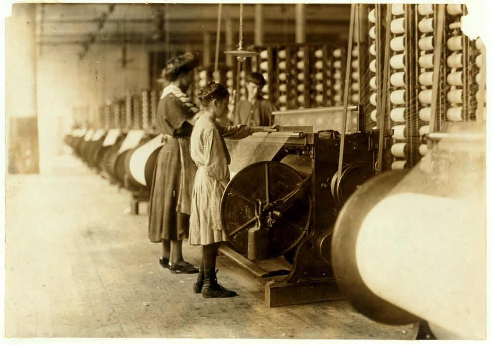 Girls running warping machines in Loray mill, Gastonia, N.C. Many boys and girls much younger. Boss carefully avoided them, and when I tried to get a photo which would include a mite of a LOC nclc.01342